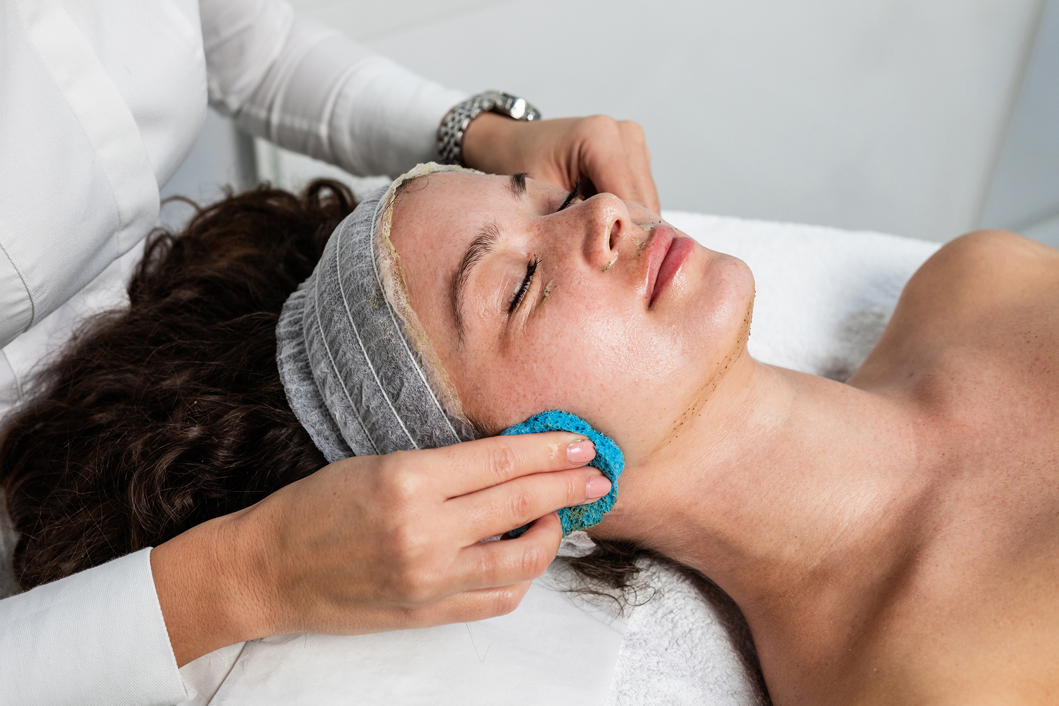 woman having facial treatment in beauty salon